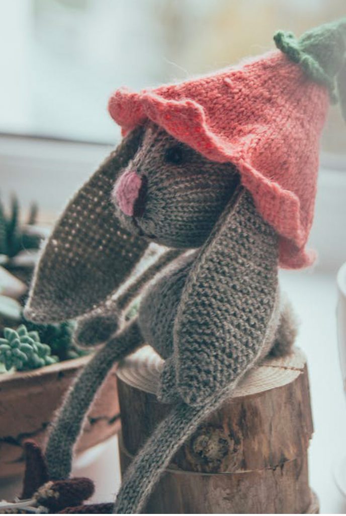 1 peluche tricotée posée sur une souche d'arbre, symbolisant la collaboration et la solidarité